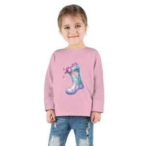 Tee - A magical illustration of a festive stocking decorated with shimmering stars and adorned with a soft pink ribbon.