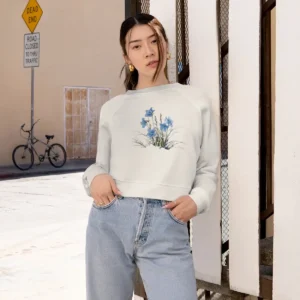 Light cropped sweatshirt with blue floral design worn by a woman