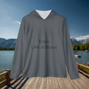 Flat lay of a gray hoodie with “Train Like a Beast” text, placed on a wooden boardwalk near a scenic mountain lake.