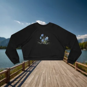 Flat lay of a black cropped sweatshirt with a blue wildflower graphic in the center