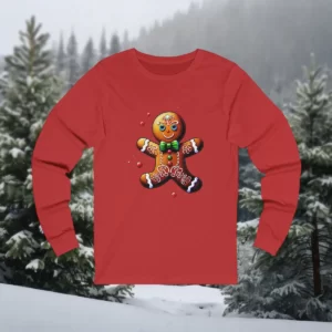 Long-sleeve shirt featuring a cheerful gingerbread man design with festive decorations, displayed against a snowy forest backdrop.