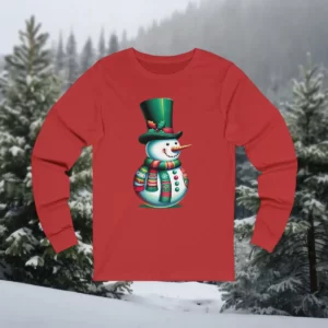 Red long-sleeve shirt featuring a festive snowman design wearing a tall green hat and colorful scarf, displayed against a snowy forest.