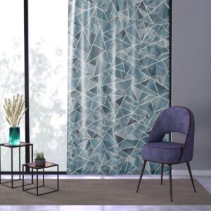 Sharp geometric angles in arctic blue and white on window curtain.