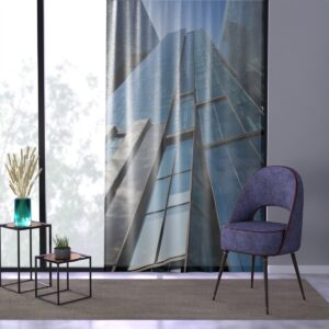 Urban-inspired window curtain with skyscraper print beside a contemporary blue chair