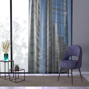 Modern cityscape printed window curtain in a room with a blue chair and side table