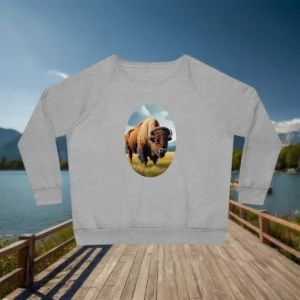 Flatlay of a grey sweatshirt with an artistic bison illustration standing in a grassy field
