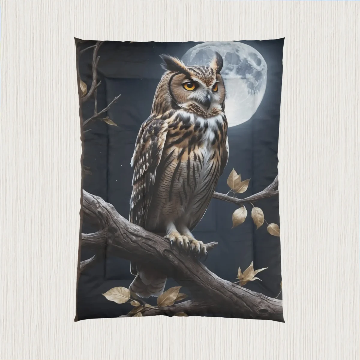 Flat-lay view of a black comforter with a realistic owl design in front of a full moon