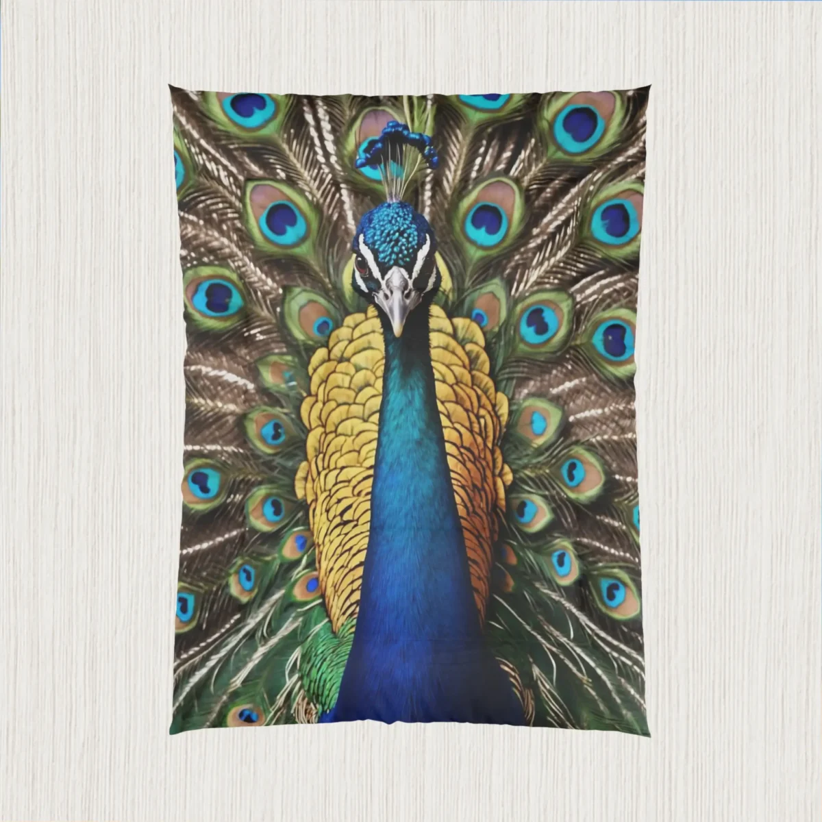 Flat view of a comforter showcasing a full-color peacock with its tail feathers spread out