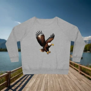 Flatlay of grey sweatshirt featuring a bold bald eagle with wings spread wide