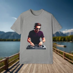 Grey raglan t-shirt laid flat on a wooden dock background, featuring a DJ graphic with headphones and turntables.