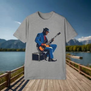 Flat lay of gray t-shirt with detailed illustration of a man in a suit playing electric guitar on amp