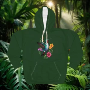 Hoodie with a hummingbird and floral design displayed in a tropical jungle setting