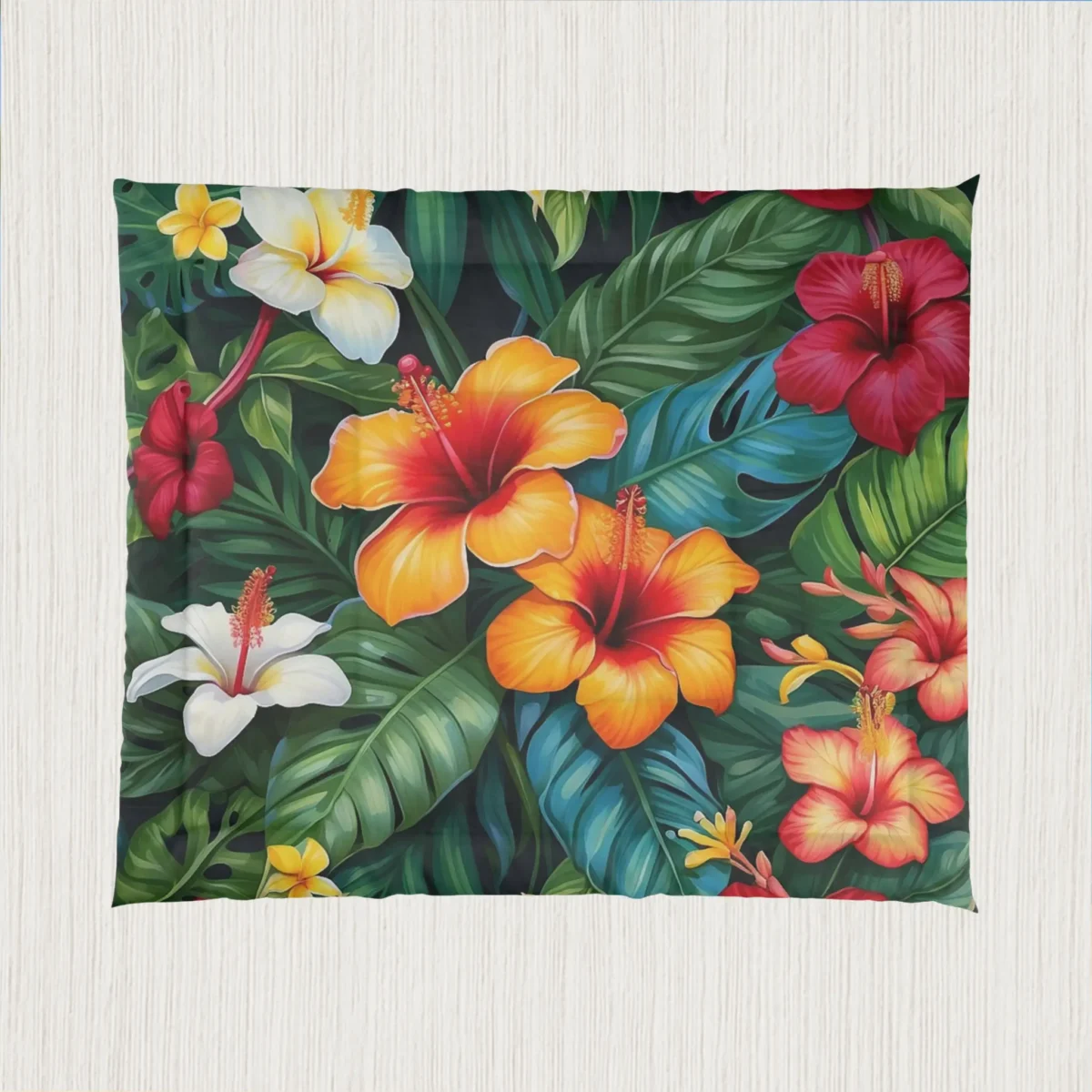 Flat view of a comforter showing colorful tropical hibiscus flowers with large jungle leaves