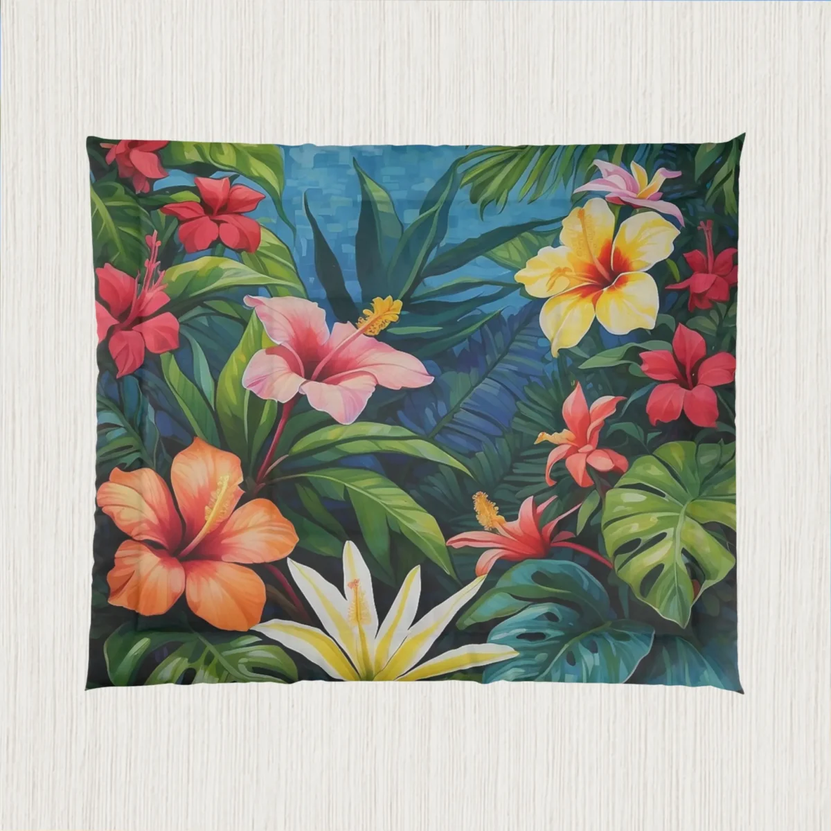 Flat view of a comforter with a dense and colorful floral pattern of hibiscus and tropical foliage