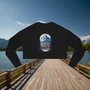 Flat lay of a black cropped sweatshirt with a city and mountain landscape graphic
