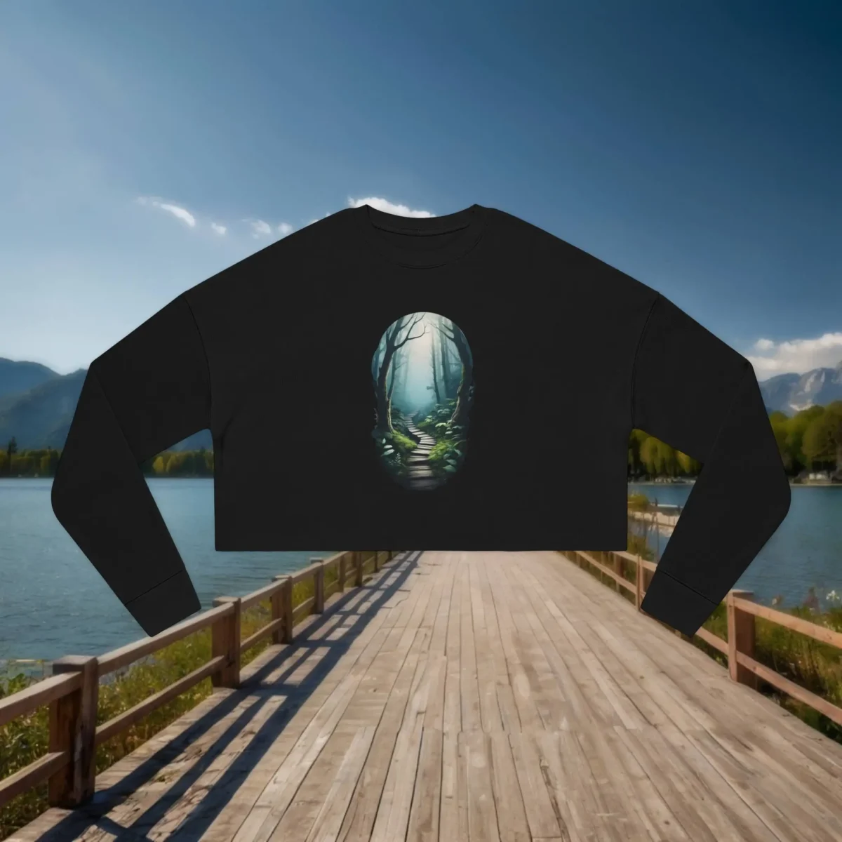 Flat lay of black cropped sweatshirt with glowing enchanted forest path graphic