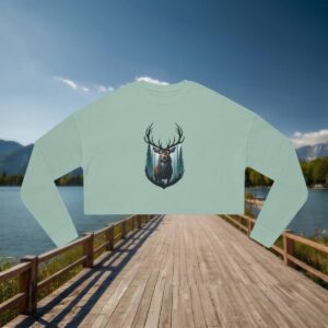 Flat-lay light green cropped sweatshirt with a bold forest stag and pine tree illustration