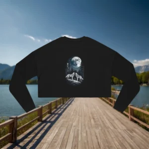 Flat lay of a black cropped sweatshirt with a wolf and full moon design in a forest scene