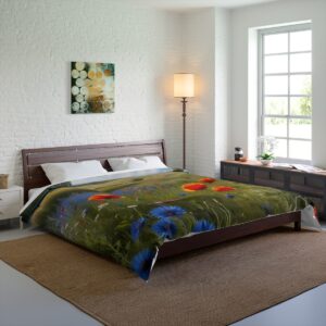 A bedroom with a Comforter showcasing a poppy field and rolling hills, placed on a bed in a bright room with a large window and wooden furniture.