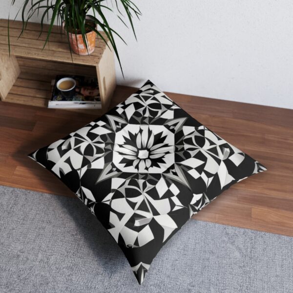 Chic cushion with black and white kaleidoscopic design of symmetrical geometric shapes