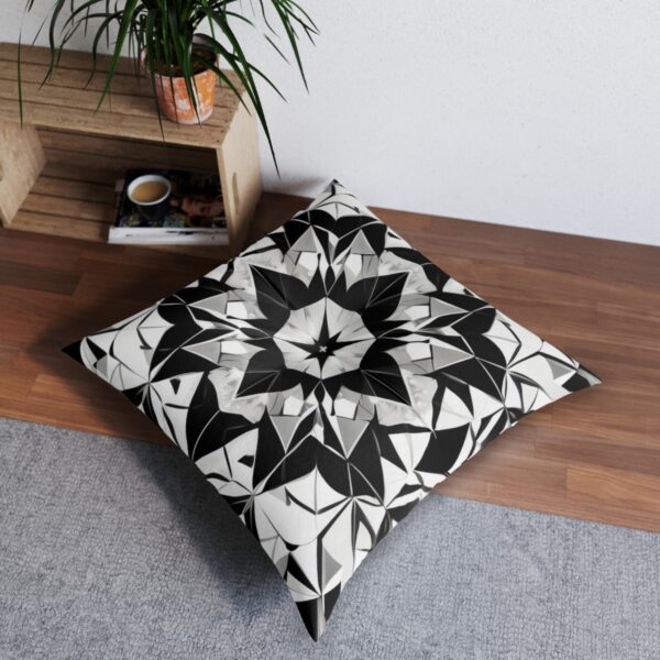 Elegant cushion with captivating kaleidoscope pattern in symmetrical black and white geometric shapes