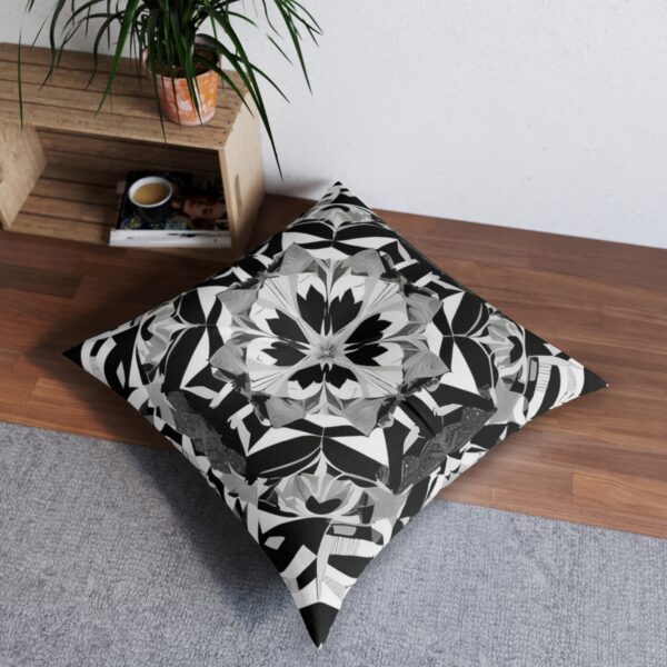 Stunning cushion with mesmerizing kaleidoscopic design in black and white geometric shapes