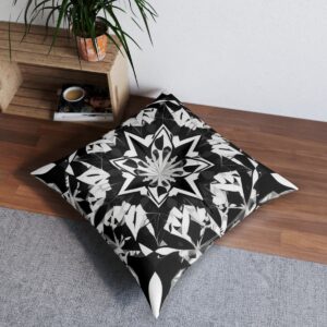 Cushion with symmetrical kaleidoscopic pattern in black and white geometric shapes