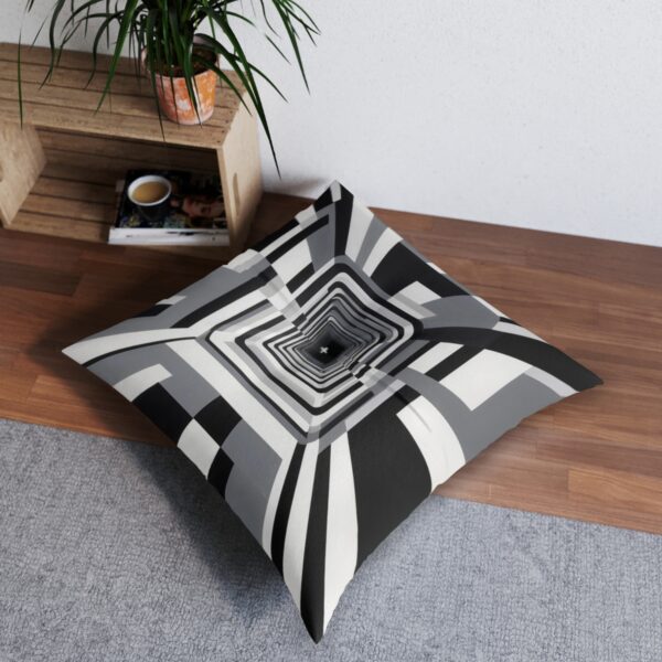 Cushion with striking concentric rectangles in monochromatic scheme creating tunnel illusion