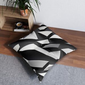 Dynamic white polygons set against stark black tufted floor pillow