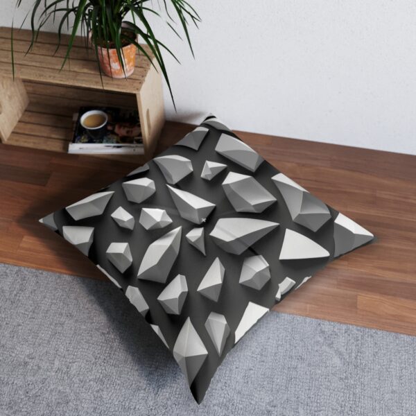 D polygon pattern tufted floor pillow with white shapes and grey shadows on black