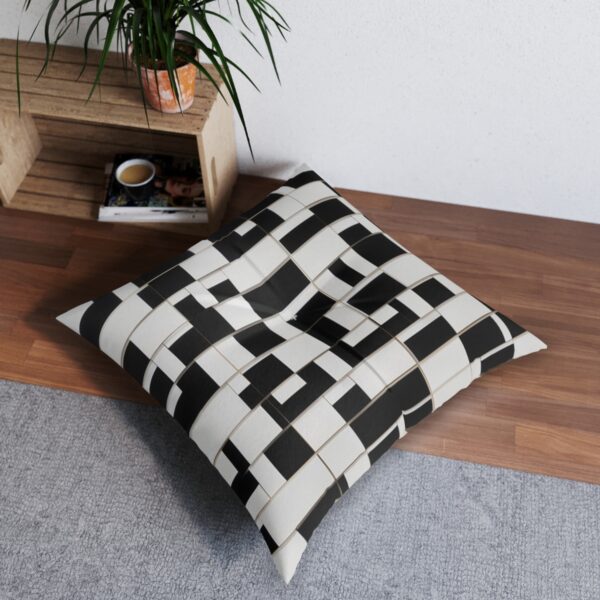 Playful grid of skewed black and white rectangles tufted floor pillow