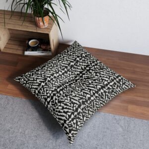 Chic modern black and white triangle tufted floor pillow in interior setting