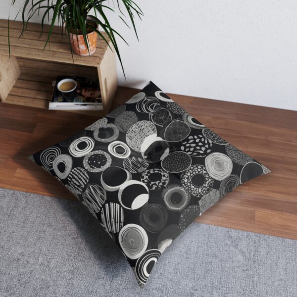 Elegant monochrome pattern tufted floor pillow in a cozy room