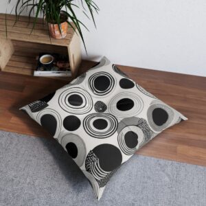 Modern black and white circle pattern tufted floor pillow in home setting