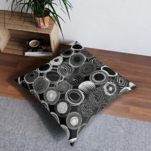 Modern design tufted floor pillow with varied monochrome patterned perfect circles