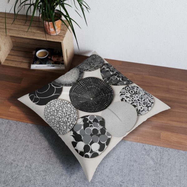 Array of perfect circles with unique monochrome patterns on tufted floor pillow