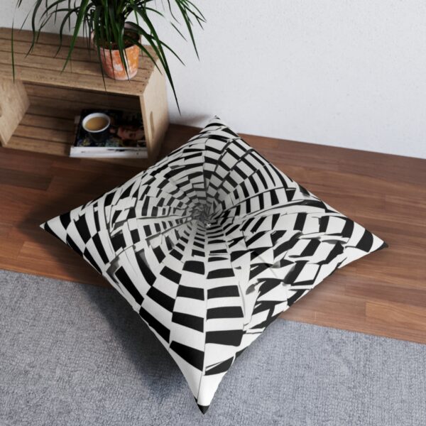 Black squares forming a captivating spiral pattern on a white tufted floor pillow