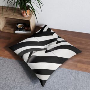 Black and white fluid vertical lines transitioning into a grid pattern on tufted floor pillow