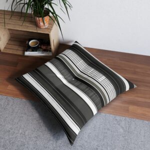 Black and white tufted floor pillow with vertical lines blending into a grid pattern