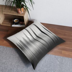 Tufted floor pillow with black and white vertical lines creating shadow and light effect