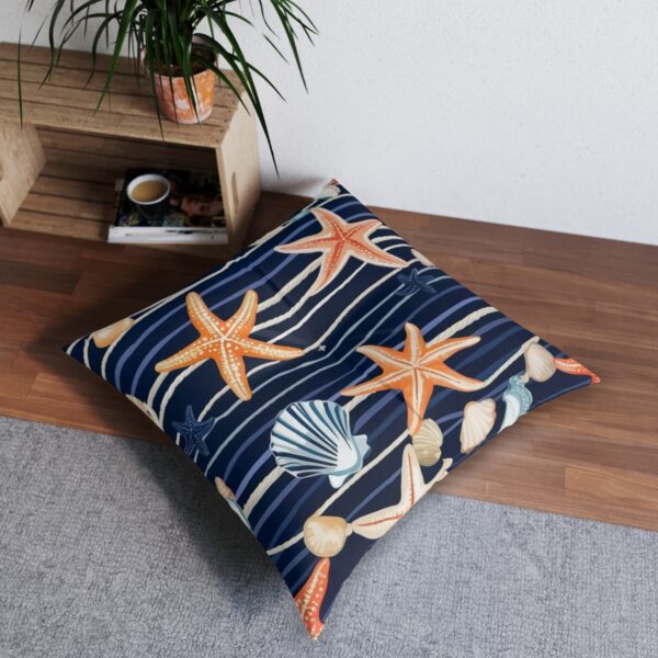 Coastal charm tufted floor pillow with starfish and seashells on navy and white stripes