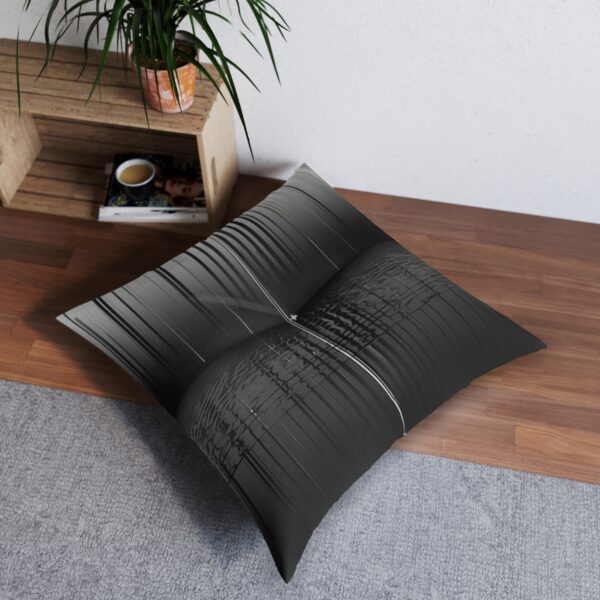 Monochromatic tufted floor pillow with vertical lines merging into grid pattern