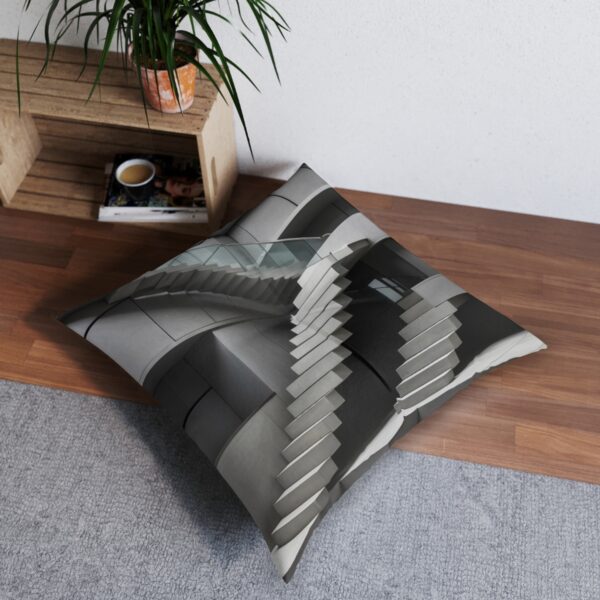 Layered gray-toned rectangular blocks creating staircase illusion on tufted floor pillow