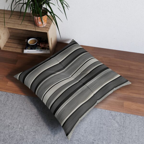 Tufted floor pillow with serene black and white wave stripe pattern