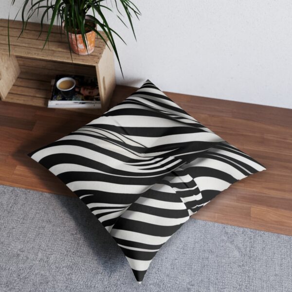 Black and white striped tufted floor pillow with elegant wave effect