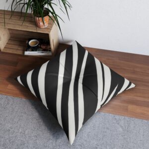 Contemporary tufted floor pillow with black and white wave stripe design