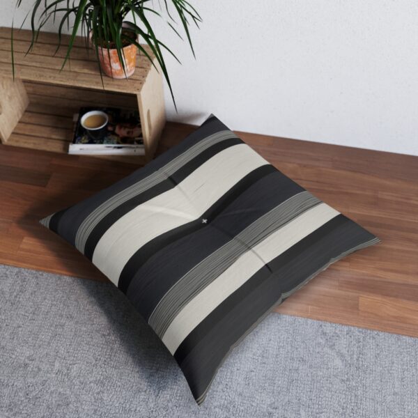 Modern tufted floor pillow with varying black and white stripes