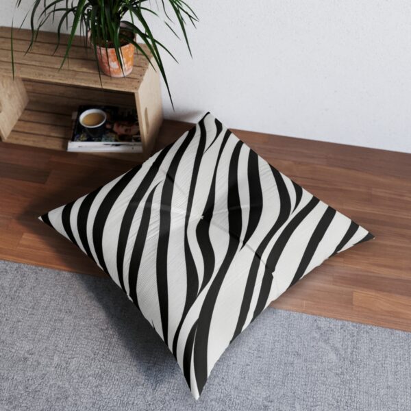 Black and white striped tufted floor pillow with wave pattern