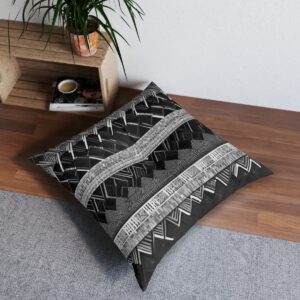 Stylish tufted floor pillow with black and white layered parallelogram design