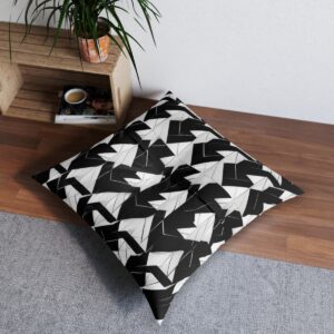 Tufted floor pillow with bold monochrome parallelograms creating depth illusion